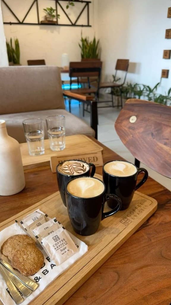 Three specialty coffees on a wooden tray